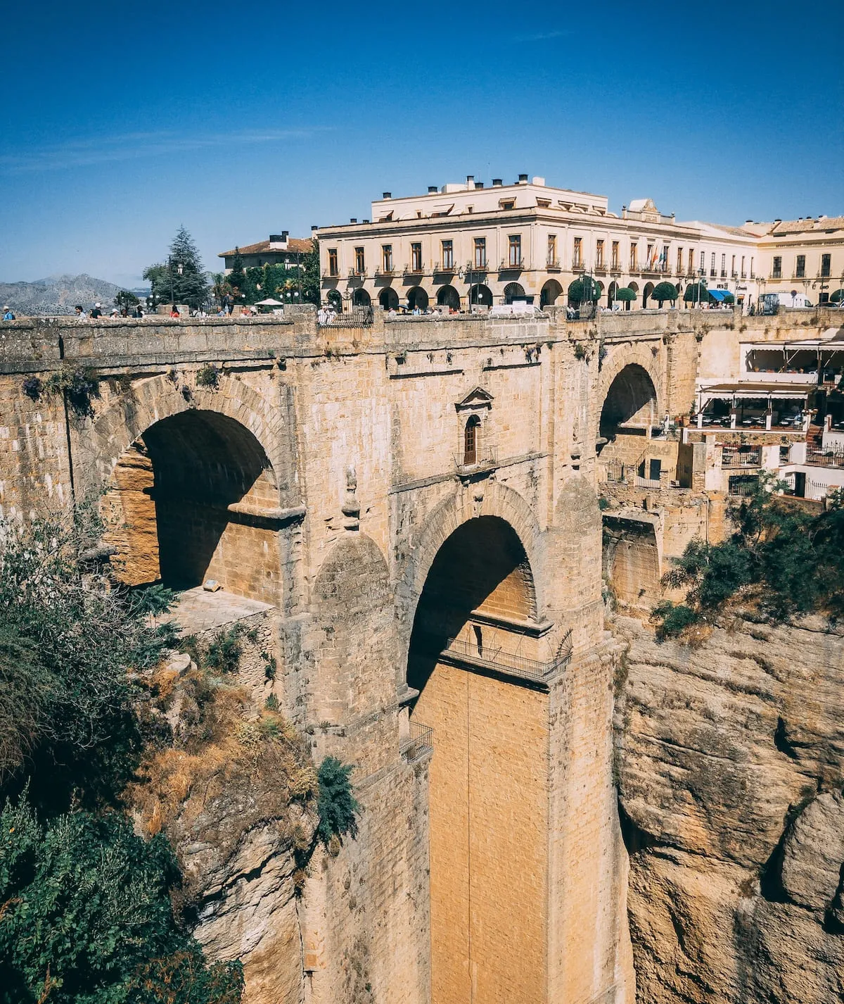 The Puente Nuevo of Ronda and its central arch over the Tajo gorge, with the Parador de Ronda behind it on Plaza de España