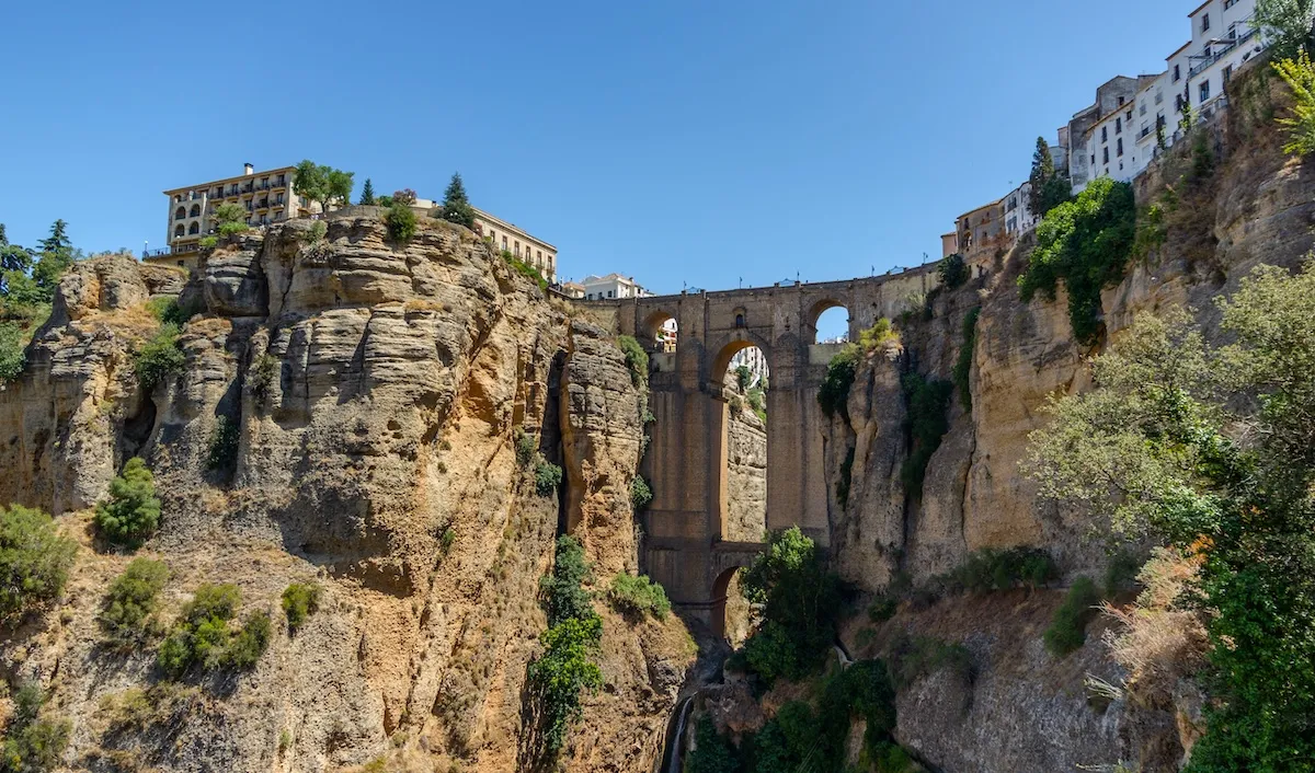 The Puente Nuevo between the rock walls of the Tajo, seen from the slopes below the town